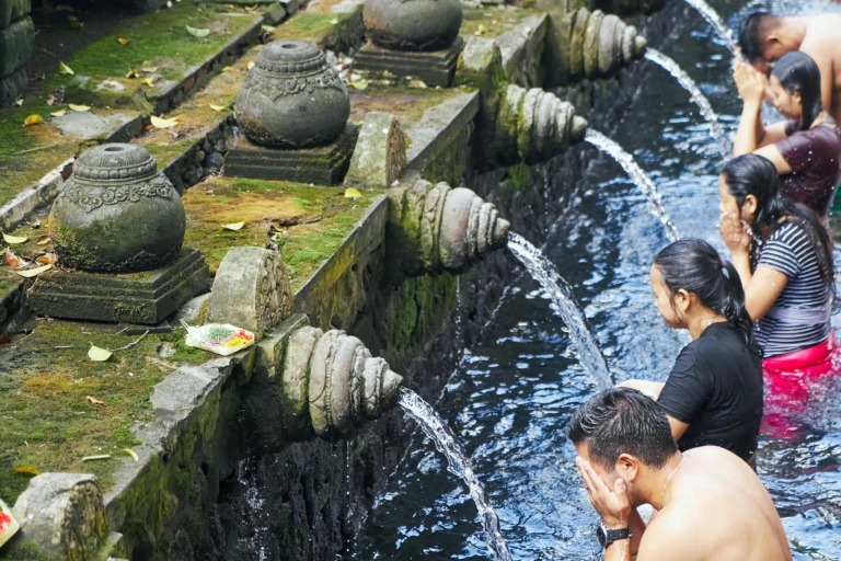 Balinese Hindu ritual bathing at Tirta Empul Temple – a sacred water purification ceremony in Bali, Indonesia, surrounded by ancient stone fountains and spiritual ambiance.