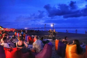Scenic view of Seminyak Beach in Bali, Indonesia, with golden sand, ocean waves, and a stunning sunset backdrop.